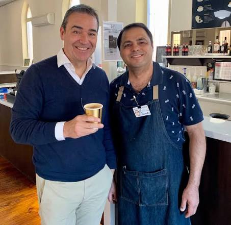 Saeid serving a notable guest a coffee at the Cafe Safavi bar