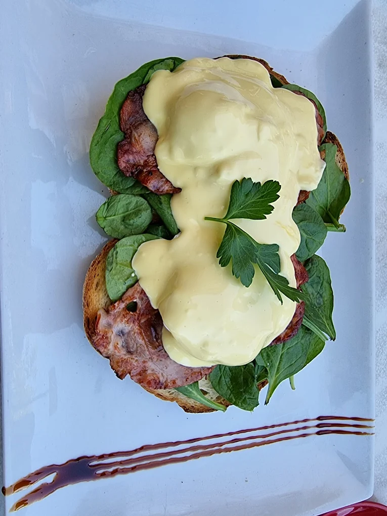 Eggs Benedict with bacon, spinach and hollandaise