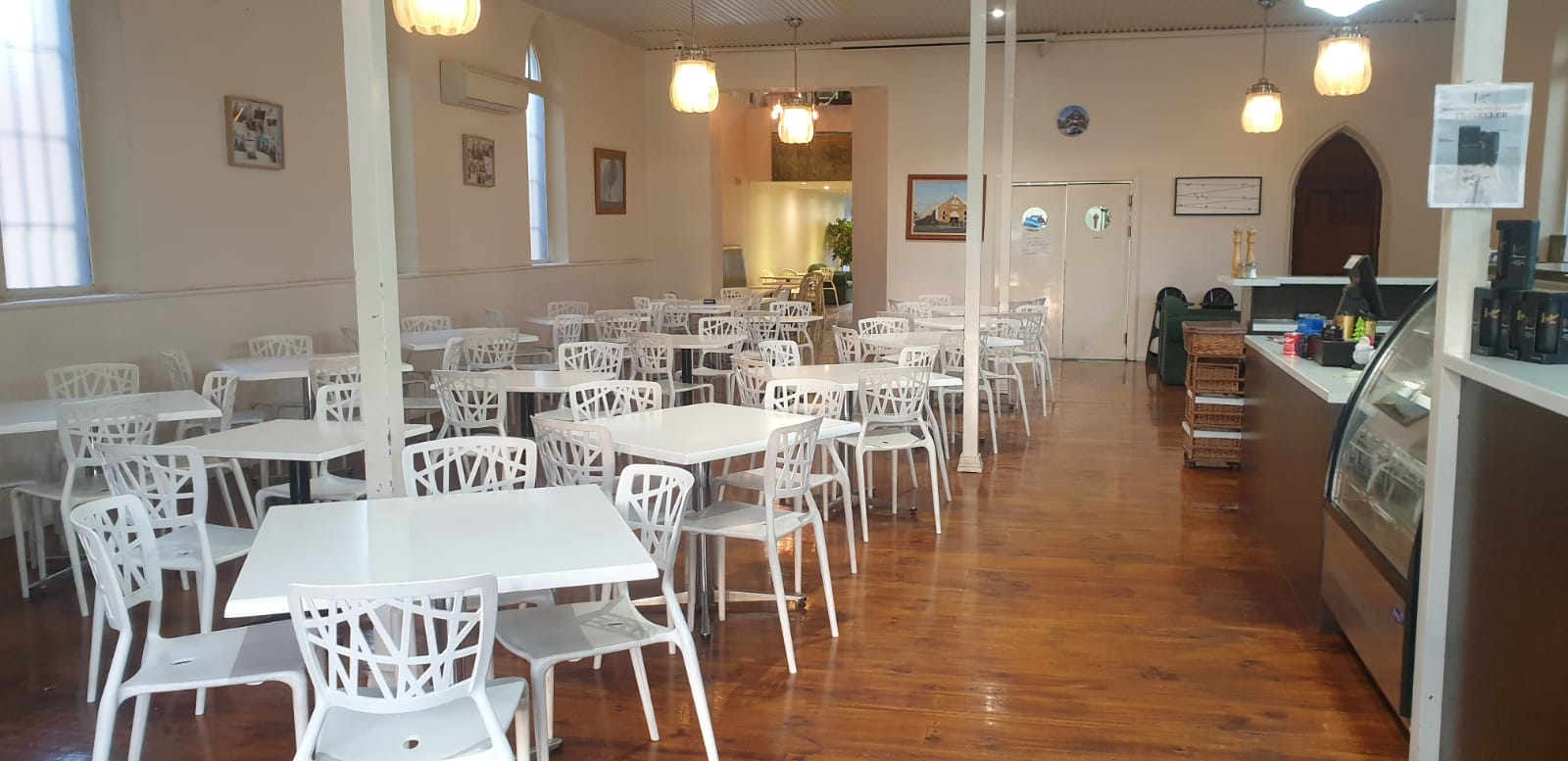 Bright dining room with white chairs and timber floors